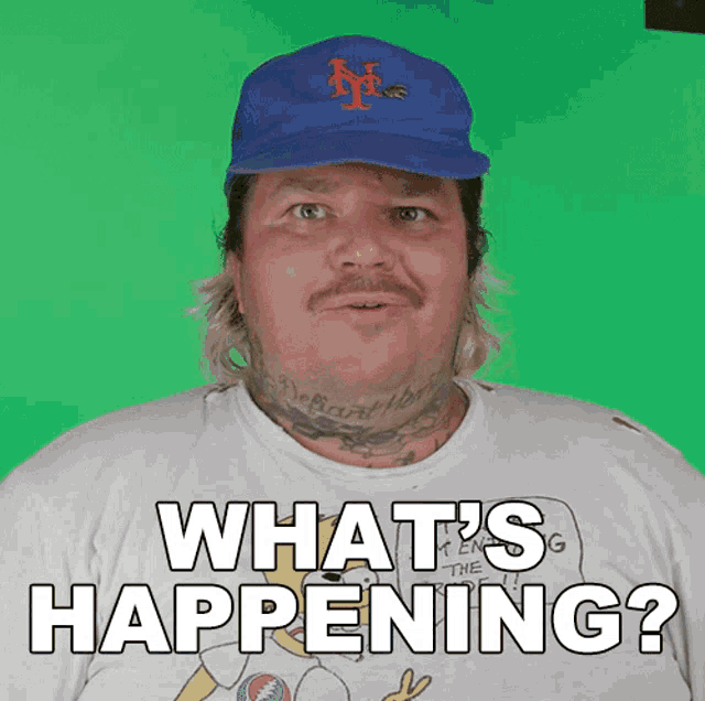 a man wearing a baseball cap and a shirt that says what 's happening