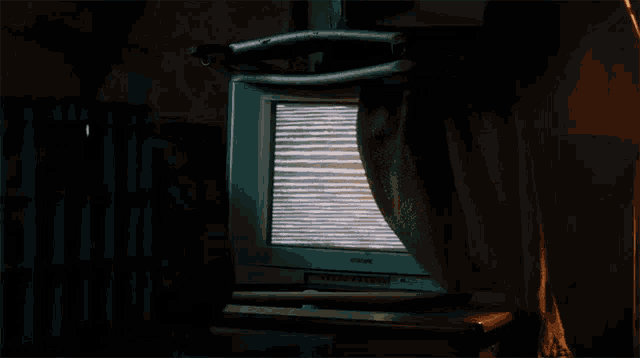 a samsung television sits on a shelf in a dark room