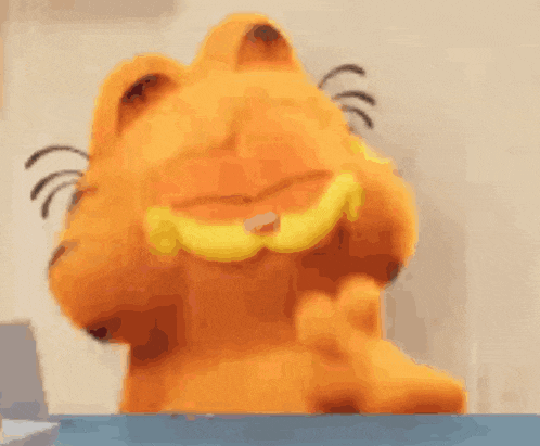 a garfield stuffed animal is sitting at a table