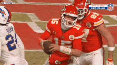 a football player with the number 5 on his helmet is being tackled by another player