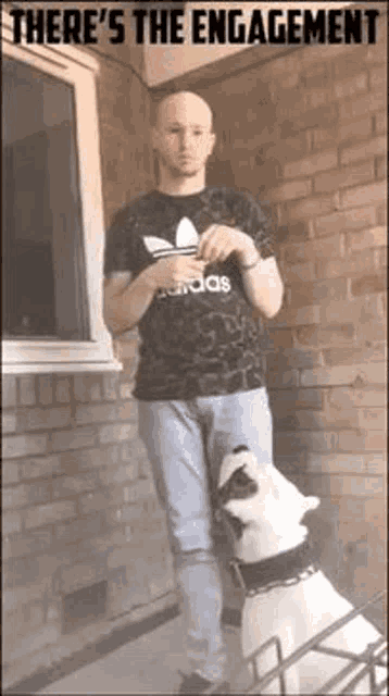 a bald man is standing next to a dog on a porch .