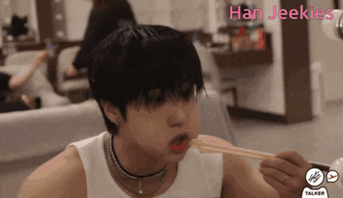 a man is eating with chopsticks and the words han jeekies are visible