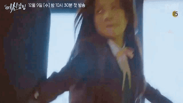a girl in a school uniform is standing in front of a window .