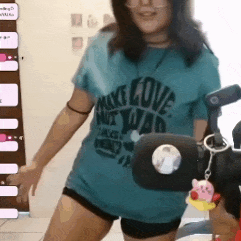a woman wearing a mike love shirt is dancing