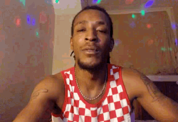 a man in a red and white checkered tank top