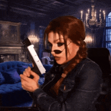 a woman in a leather jacket is holding a gun in a living room