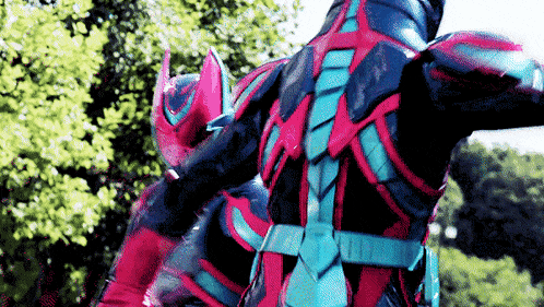 a man in a red and blue superhero costume is standing in front of a forest .