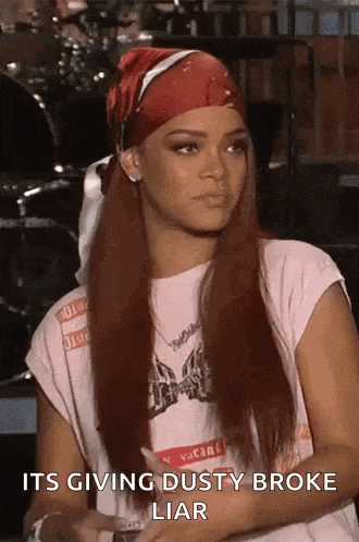 a woman wearing a bandana and a t-shirt is sitting down and talking .