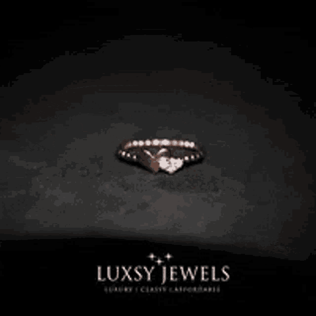 a close up of a rose gold bracelet with diamonds on a black background .
