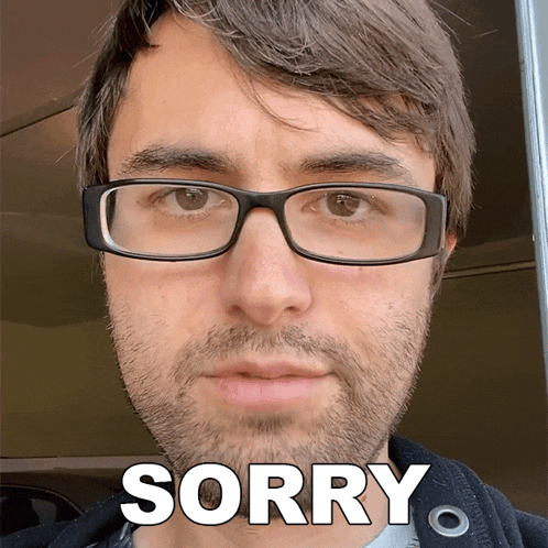 a man with glasses and a beard says " sorry "