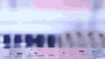 a blurry picture of a pink and blue background with a few lines .