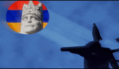 a statue of a man with a crown is surrounded by a flag
