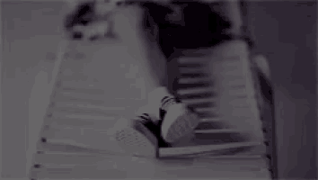 a woman laying on a bed with her feet up