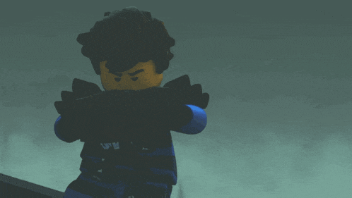 a lego figure with black hair and a yellow face is standing in the dark