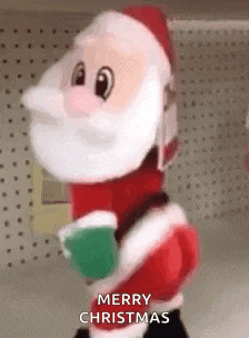 a stuffed santa claus is standing in a store holding a cup of coffee and saying merry christmas .