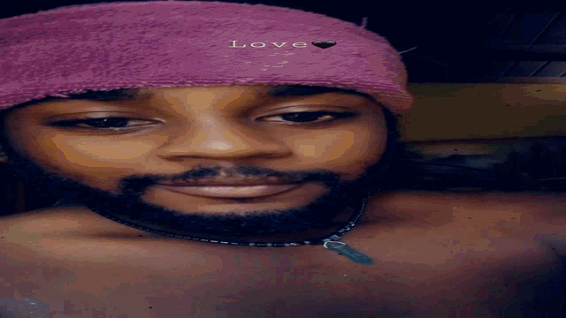 a man wearing a pink towel that says love on it