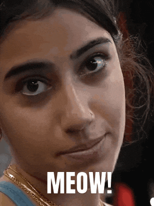 a close up of a woman 's face with meow written on it