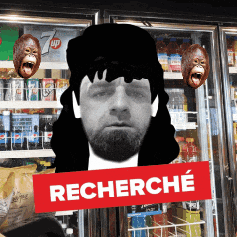 a man with a beard is standing in front of a fridge with a sign that says recherche