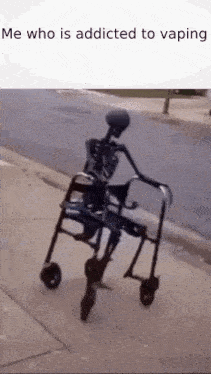 a skeleton is riding a walker on a sidewalk .