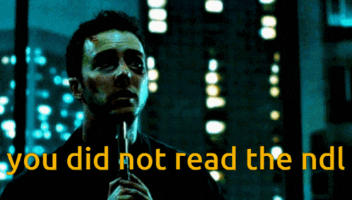 a man holding a microphone with the words " you did not read the nd " behind him
