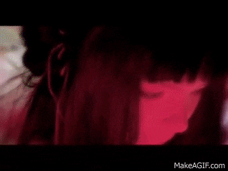 a woman laying on a bed with her legs crossed and a make a gif.com url at the bottom