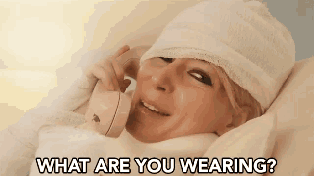 a woman with a bandage on her head is talking on a phone with the words " what are you wearing " above her