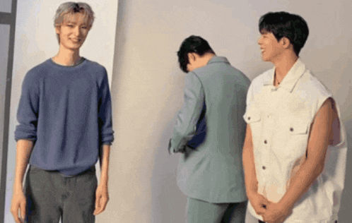 a group of young men are standing next to each other in a room .