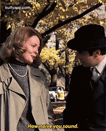 a man and a woman are standing next to each other and the woman is talking to the man .
