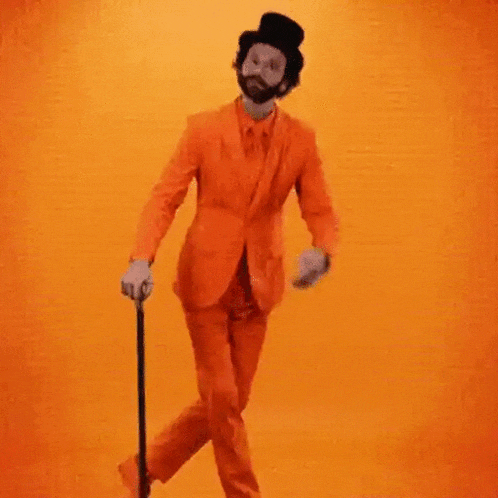 a man in an orange suit is holding a cane