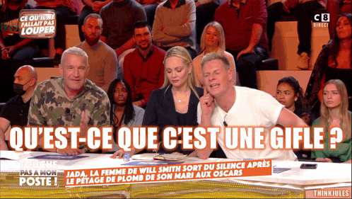 a group of people are sitting in front of a sign that says think jules