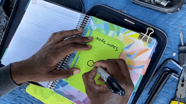 a person is writing on a notebook that says more notes on it