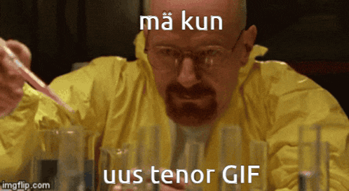 a man in a yellow jacket is sitting at a table with beakers and the words ma kun uus tenor gif