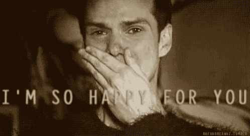 a man is covering his mouth with his hand while laughing .