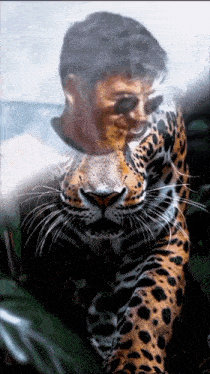 a man is hugging a leopard with a leopard 's face on his face