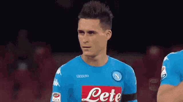 a soccer player wearing a blue shirt that says lete on it