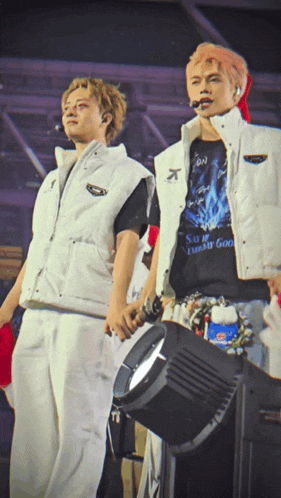 two men standing next to each other with one wearing a shirt that says ' so i 'm a dream good '