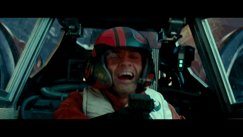 a man wearing a helmet that says ' a ' on it is sitting in a car