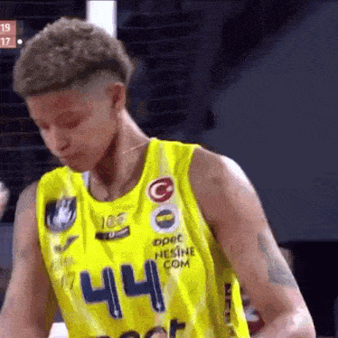 a basketball player is wearing a yellow jersey with the number 44 on it