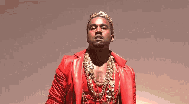 a man wearing a crown and a red jacket