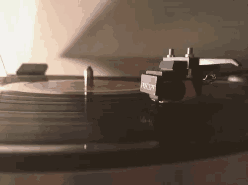 a record player is playing a record with a phono pickup