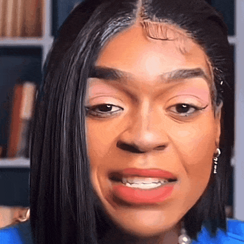 a close up of a woman 's face with a wig on her head .