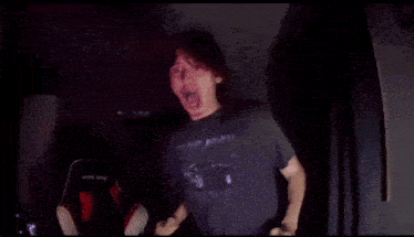 a man is making a heart shape with his hands in front of a camera .