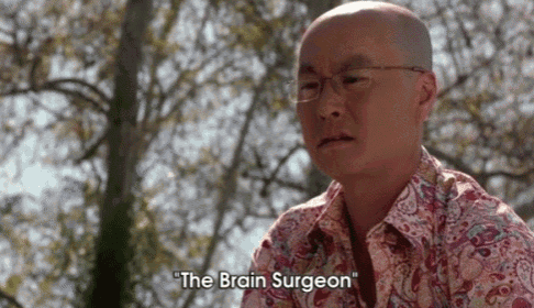 a bald man wearing glasses and a paisley shirt says " the brain surgeon " .