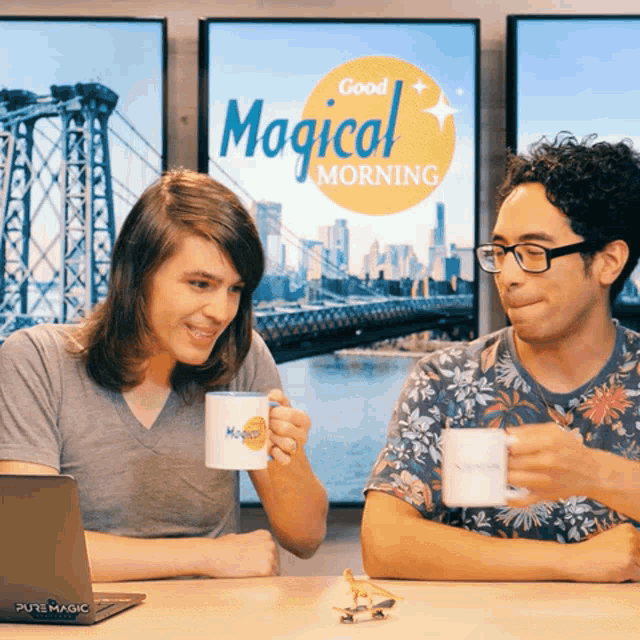 two men are sitting at a table with cups of coffee in front of a sign that says good magical morning