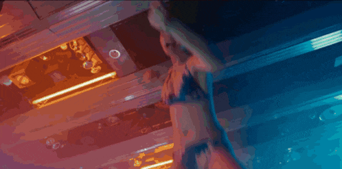 a blurry picture of a woman 's face with a purple and blue background