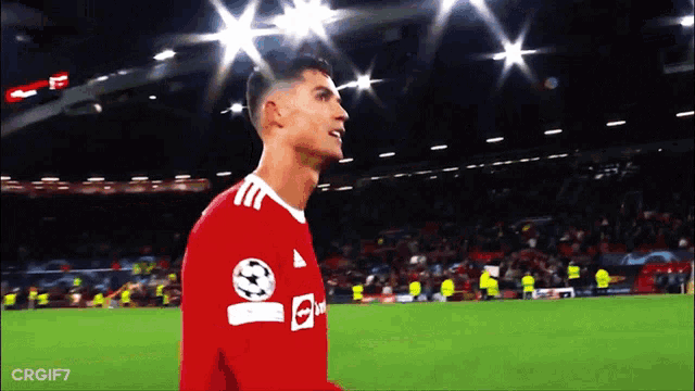 a soccer player wearing a red jersey that says ' uae ' on it