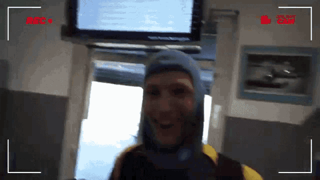 a man in a scuba suit is being recorded by a camera with a rec button