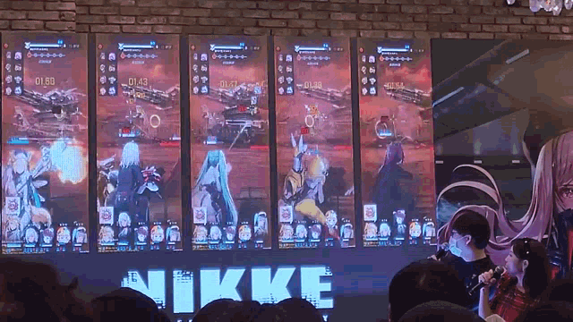 a group of people are watching a video game with the word nikke in the corner