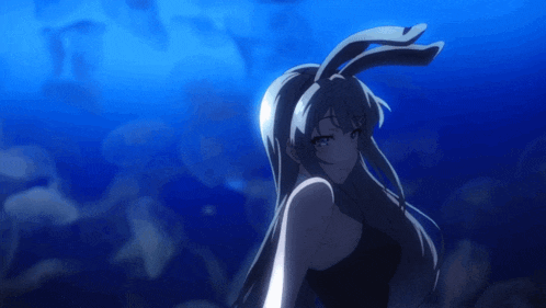 a girl with bunny ears is standing in a dark room