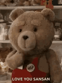 a teddy bear is wearing a red apron and holding a heart and says `` love you sansan '' .